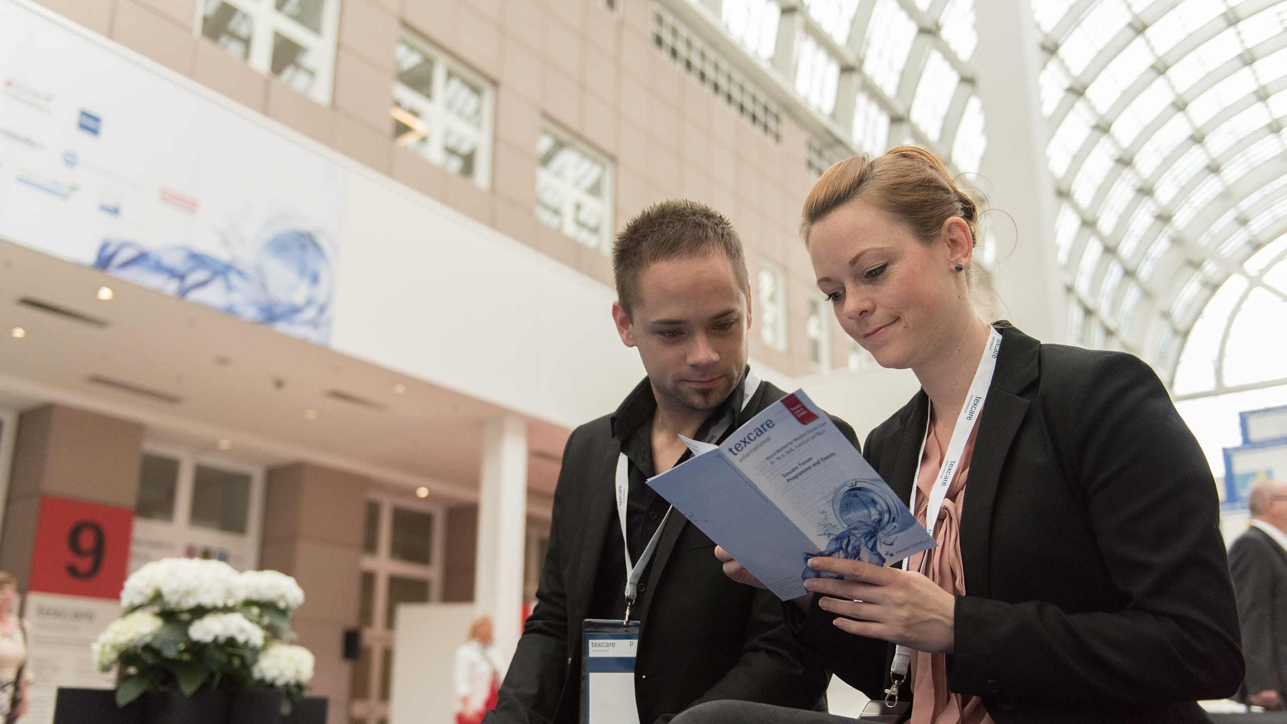 Fair visitors with a flyer